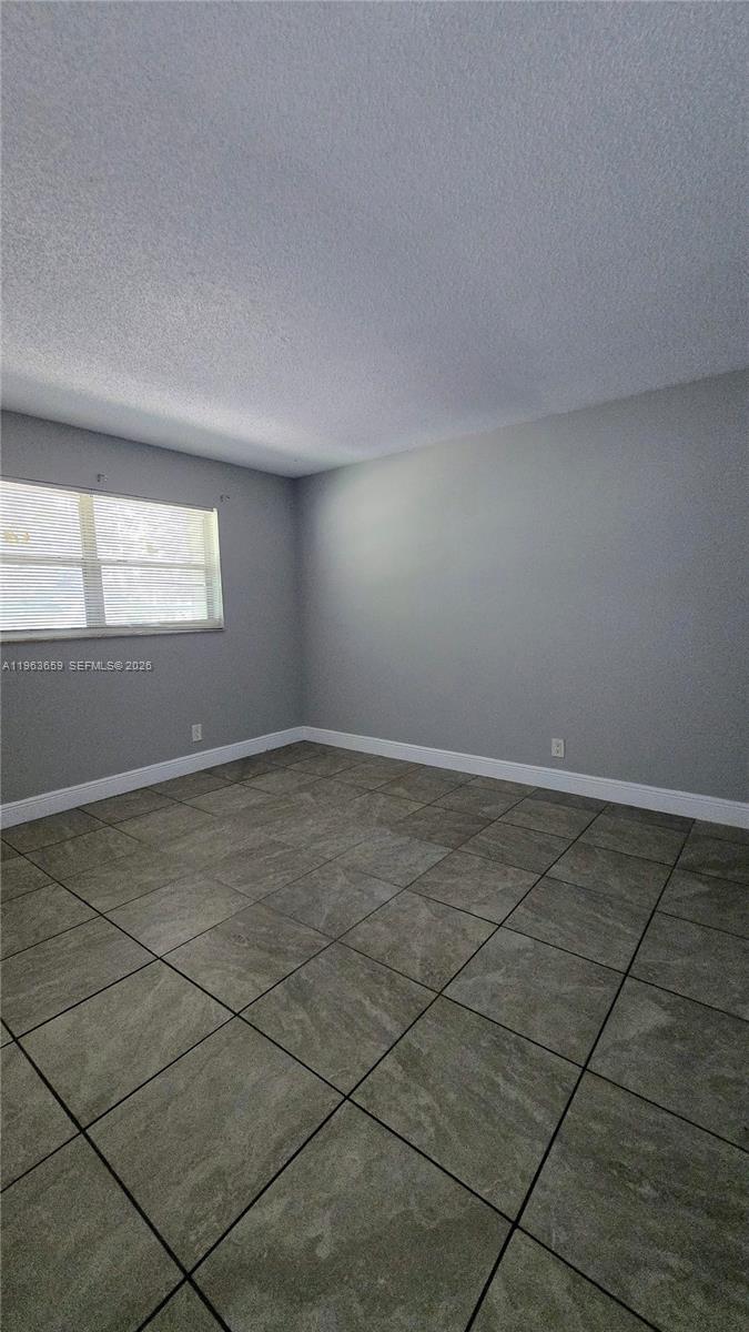 7925 Fairview Drive, Unit 206 Tamarac, FL 33321 - Photo 8 of 21 an empty room with a empty space and windows