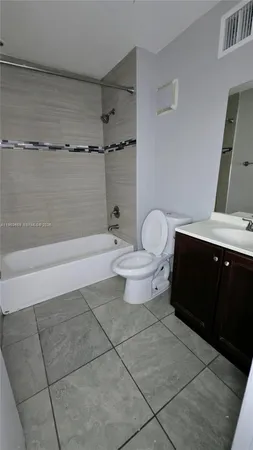 a bathroom with a toilet a sink and shower
