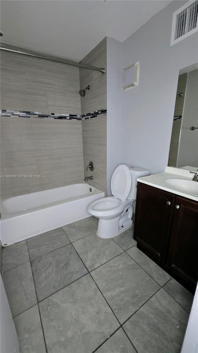 7925 Fairview Drive, Unit 206 Tamarac, FL 33321 - Photo 10 of 21 a bathroom with a toilet a sink and shower