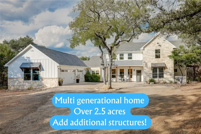 a view of a white house with large windows