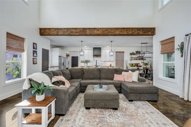 a kitchen with a table chairs and white cabinets