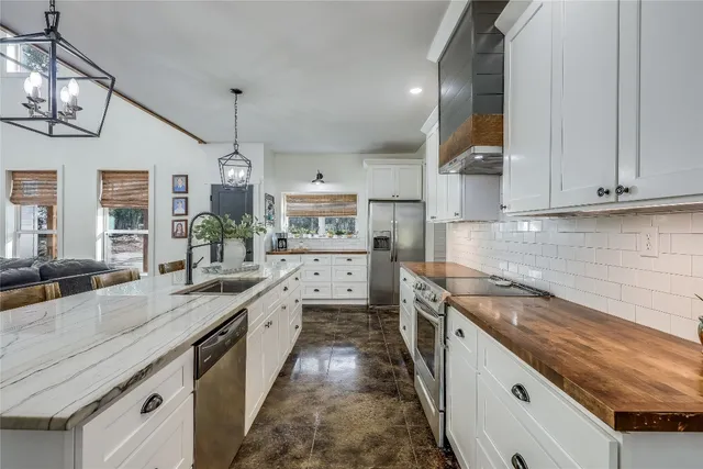 a spacious bathroom with a granite countertop sink mirror and shower