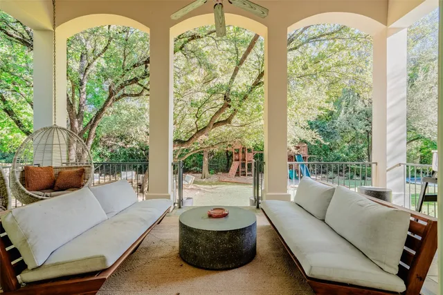a living room with furniture and a floor to ceiling window