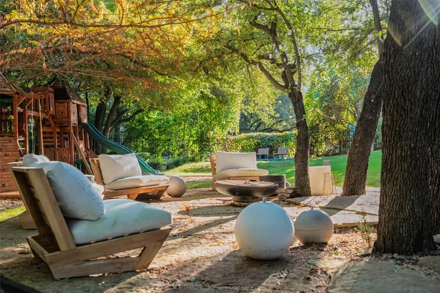 a backyard of a house with table and chairs