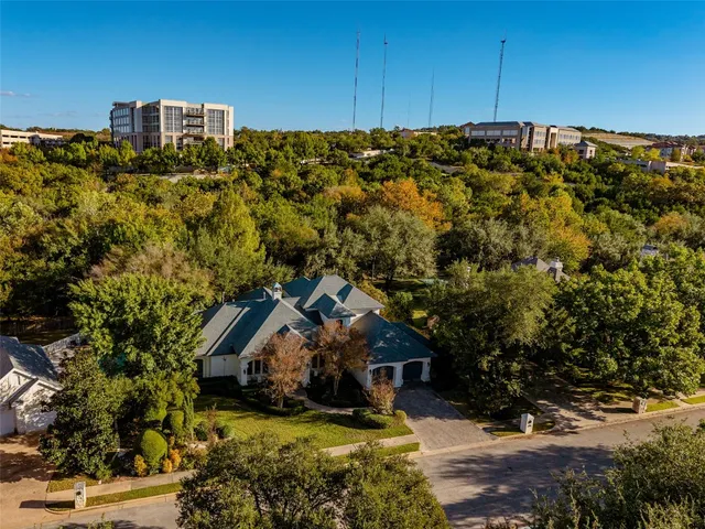 an aerial view of a house with a yard