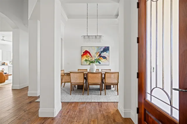 a view of dining room with wooden floor and furniture