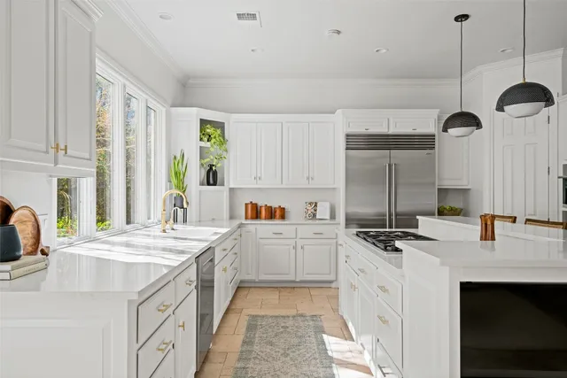 a kitchen with a stove a sink a refrigerator and a center island