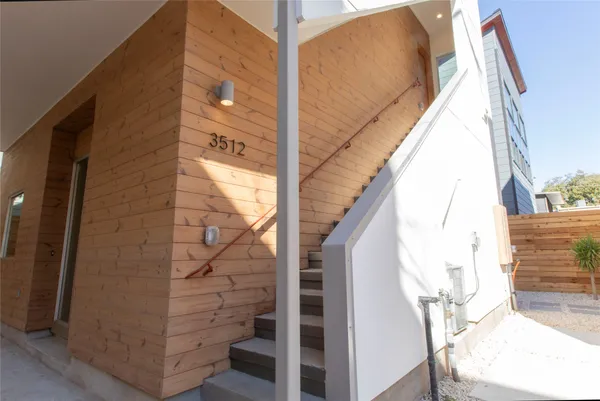 a view of a balcony with wooden floor and door