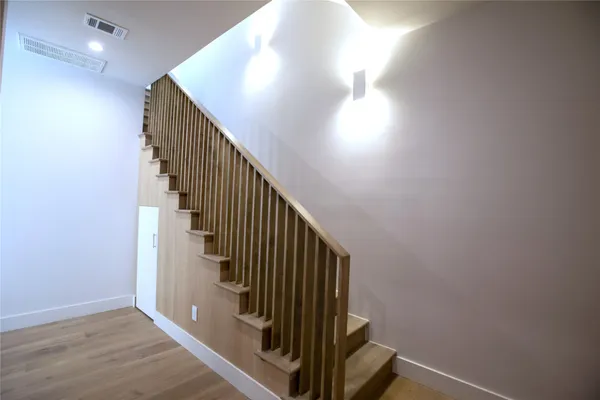 a view of entryway and hall with wooden floor