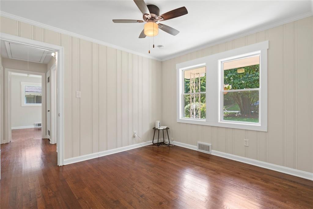 2483 Hunting Valley Drive Decatur, GA 30033 - Photo 13 of 24 an empty room with wooden floor chandelier fan and windows