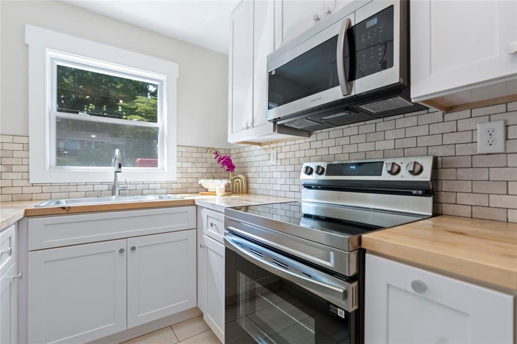2483 Hunting Valley Drive Decatur, GA 30033 - Photo 2 of 24 a kitchen with stainless steel appliances a stove sink and microwave