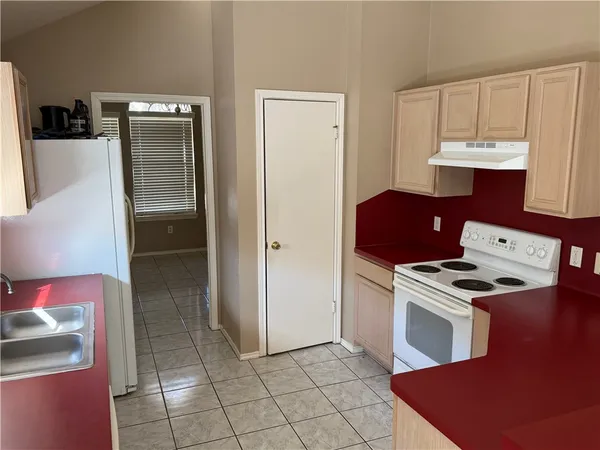 a kitchen with cabinets and steel appliances