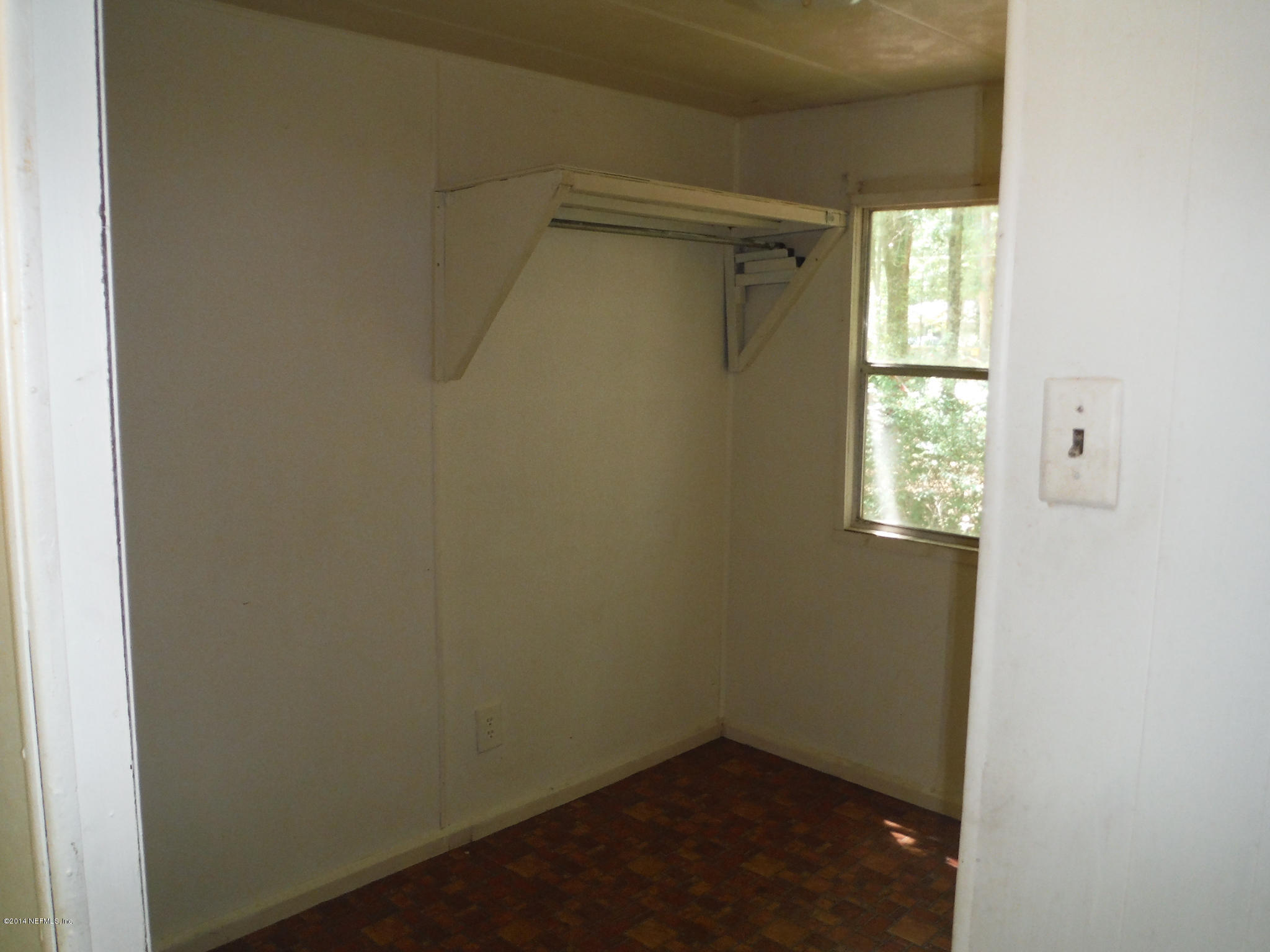 6083 Taylor Road Jacksonville, FL 32234 - Photo 8 of 16 an empty room with a window