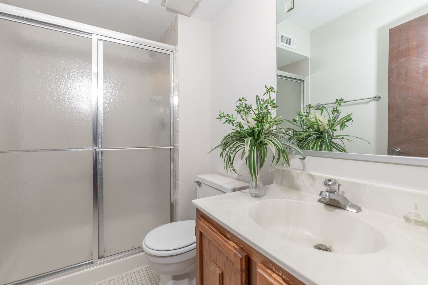 486 Timber Ridge Drive, Unit 102 Carol Stream, IL 60188 - Photo 16 of 23 a bathroom with a sink toilet and shower