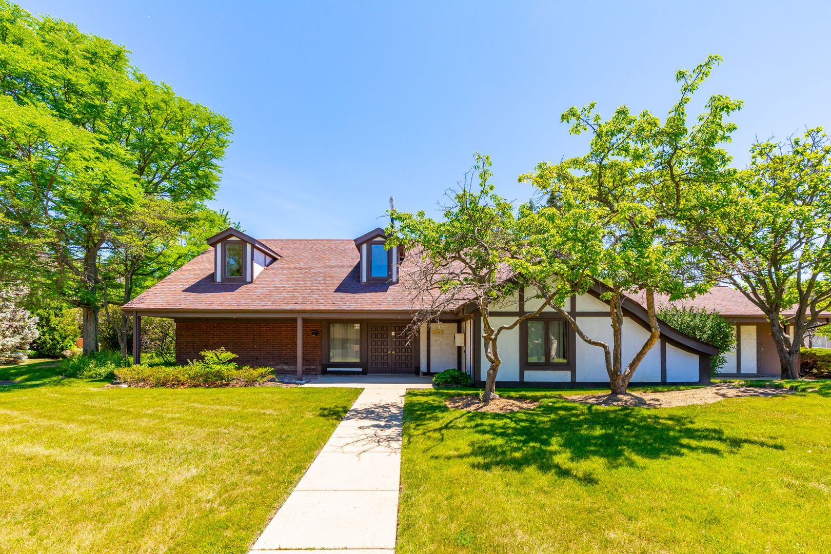 486 Timber Ridge Drive, Unit 102 Carol Stream, IL 60188 - Photo 19 of 23 a front view of a house with garden