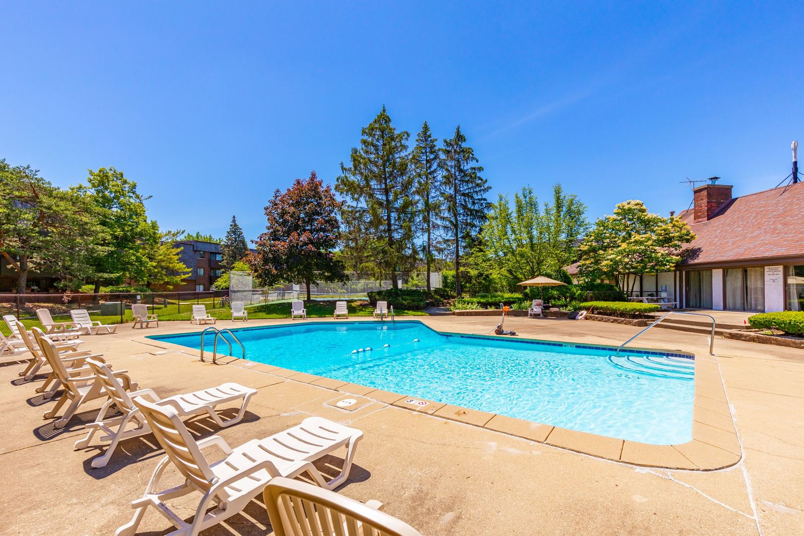 486 Timber Ridge Drive, Unit 102 Carol Stream, IL 60188 - Photo 21 of 23 a view of a swimming pool with lounge chairs