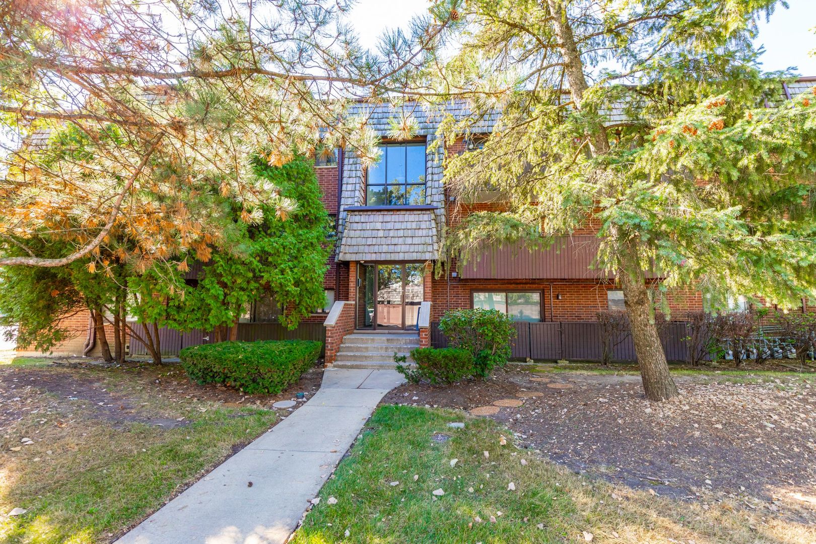 486 Timber Ridge Drive, Unit 102 Carol Stream, IL 60188 - Photo 23 of 23 front view of a house with a tree
