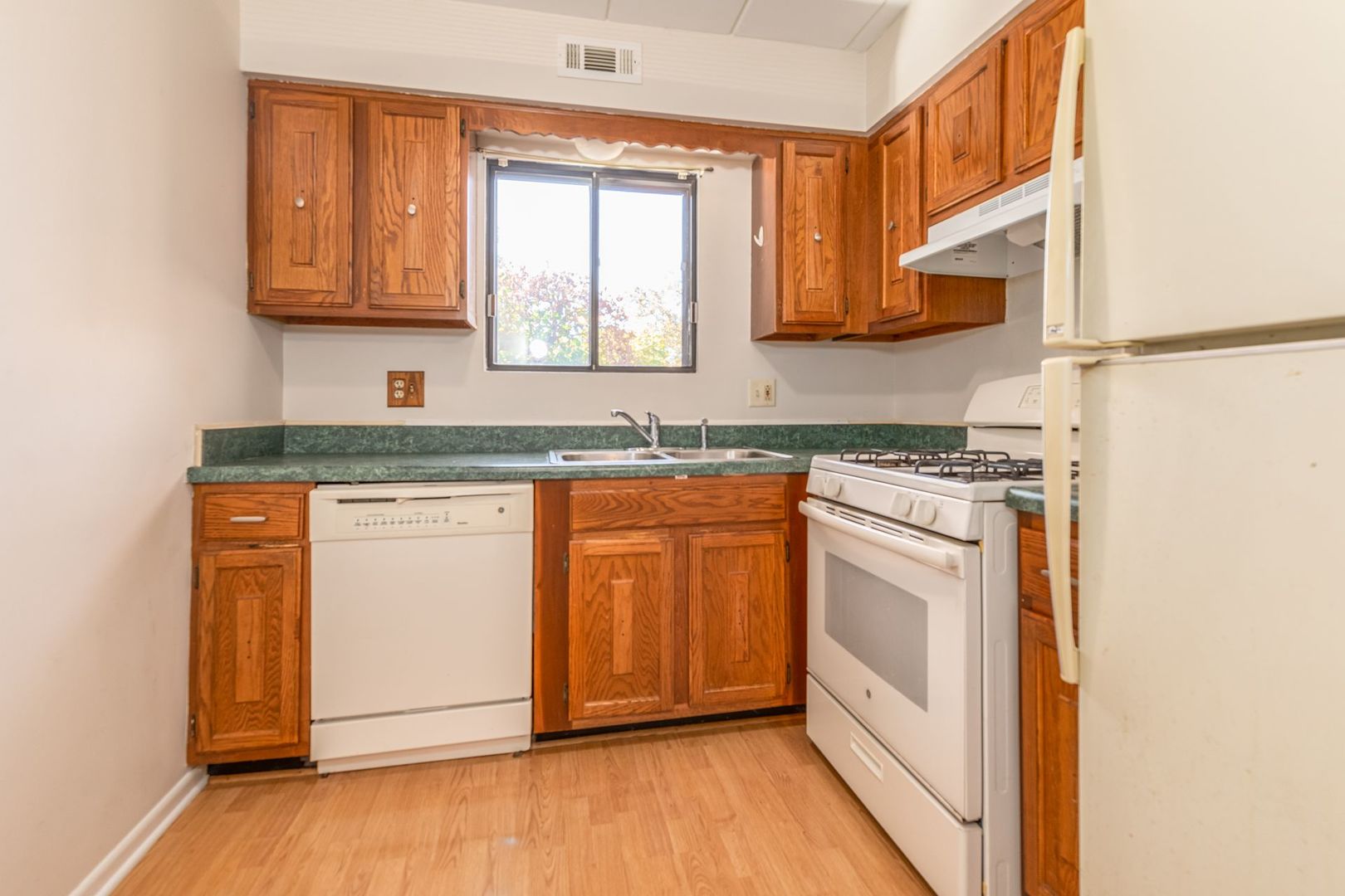 486 Timber Ridge Drive, Unit 102 Carol Stream, IL 60188 - Photo 9 of 23 a kitchen with stainless steel appliances granite countertop a stove a sink and a microwave
