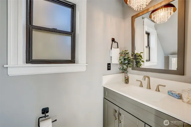 a bathroom with a sink a mirror and a window