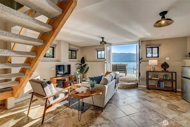 a living room with fireplace furniture and a chandelier