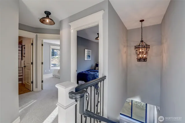 a view of a hallway to a livingroom with furniture