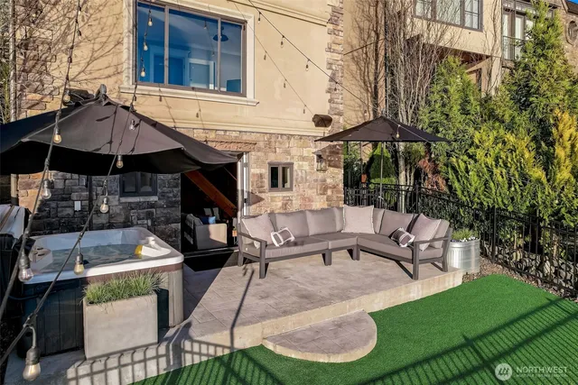 a patio with a table and chairs under an umbrella