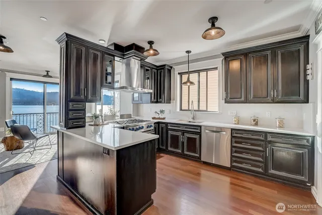 a spacious kitchen with stainless steel appliances granite countertop a sink stove and refrigerator