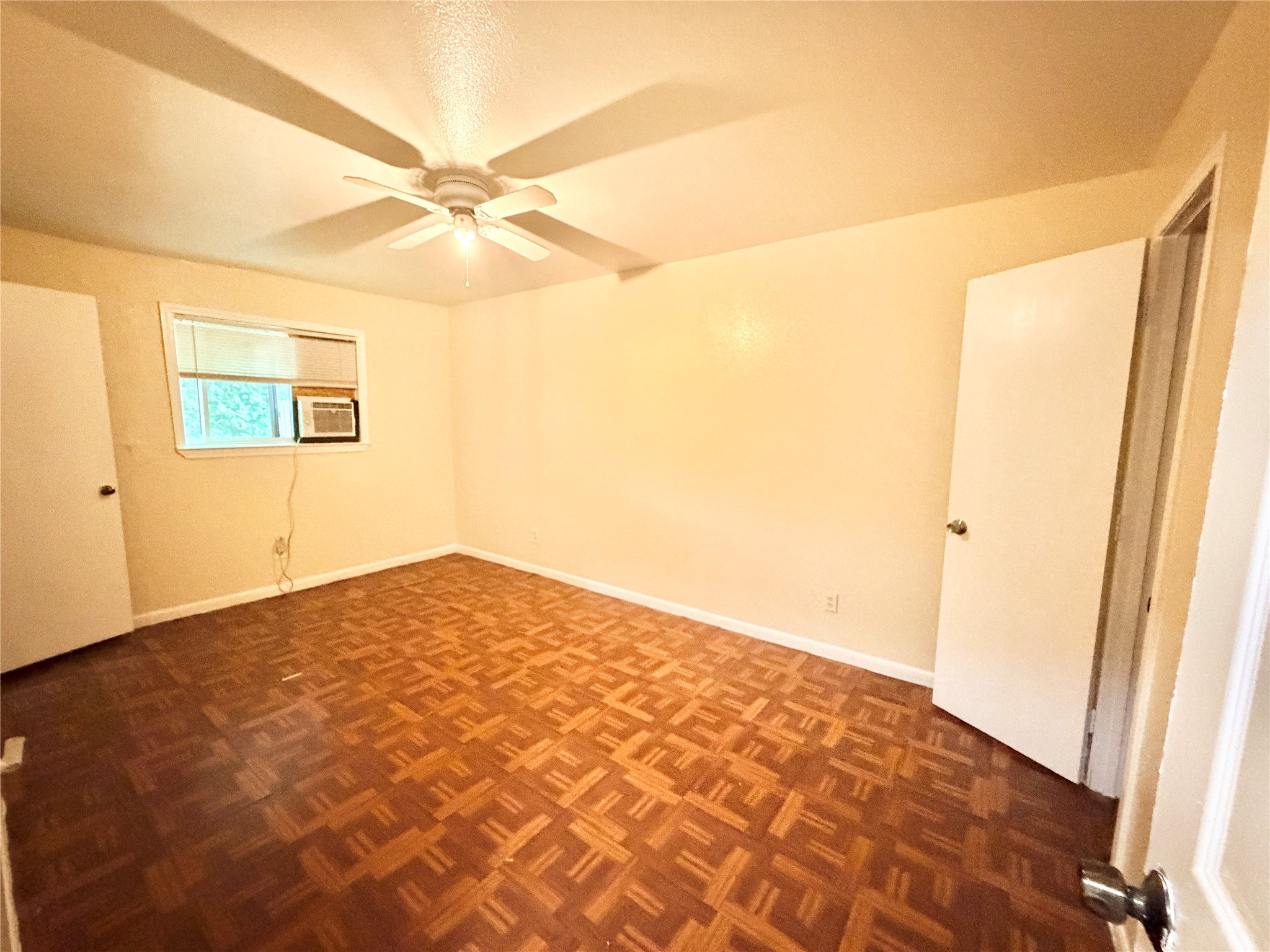 6257 Manor Road, Unit B Austin, TX 78723 - Photo 20 of 38 Room featuring patterned wood-finish flooring and a ceiling fan