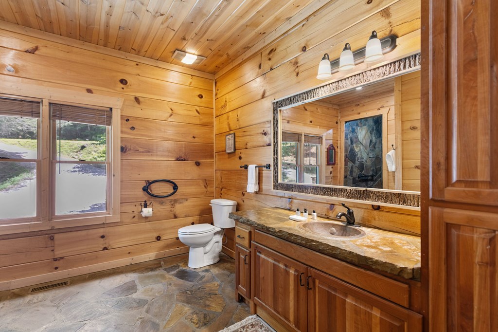 1082 Sunset Road Epworth, GA 30541 - Photo 53 of 69 a bathroom with a granite countertop sink mirror and toilet