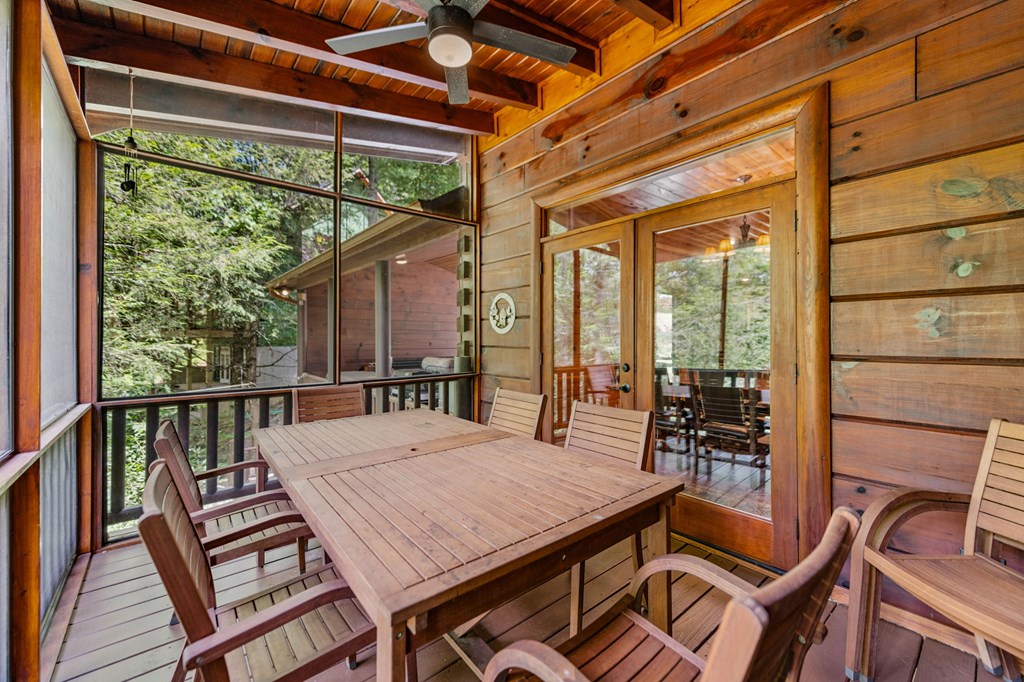 1082 Sunset Road Epworth, GA 30541 - Photo 62 of 69 a view of a patio with table and chairs and wooden floor