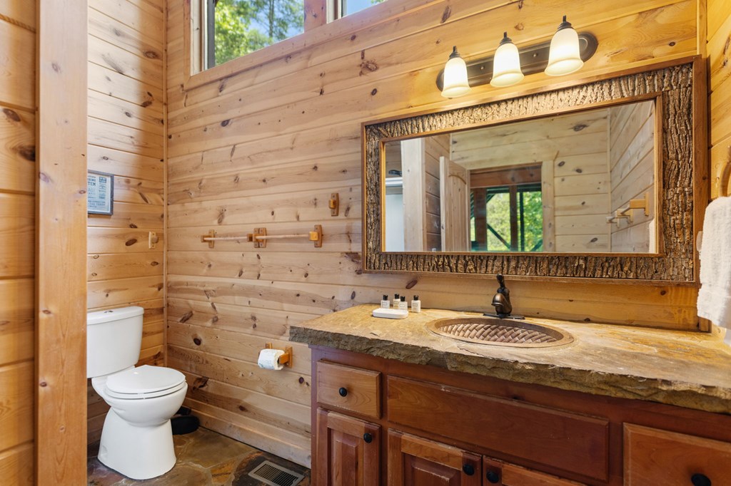 1082 Sunset Road Epworth, GA 30541 - Photo 67 of 69 a bathroom with a granite countertop toilet sink and mirror