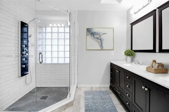 a bathroom with a shower sink and mirror