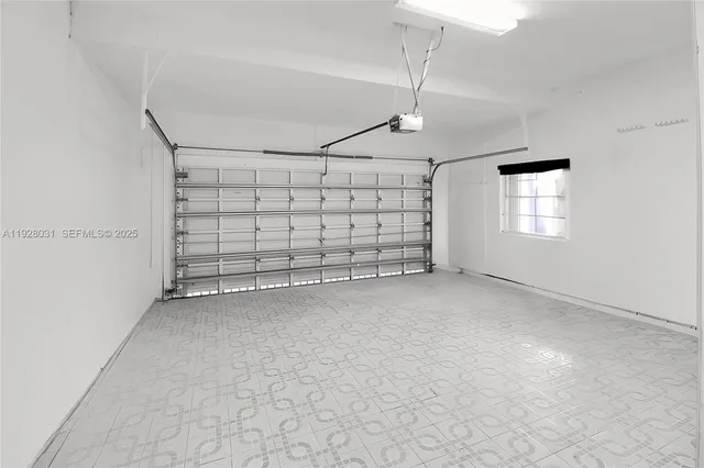 an empty room with windows and ceiling fan