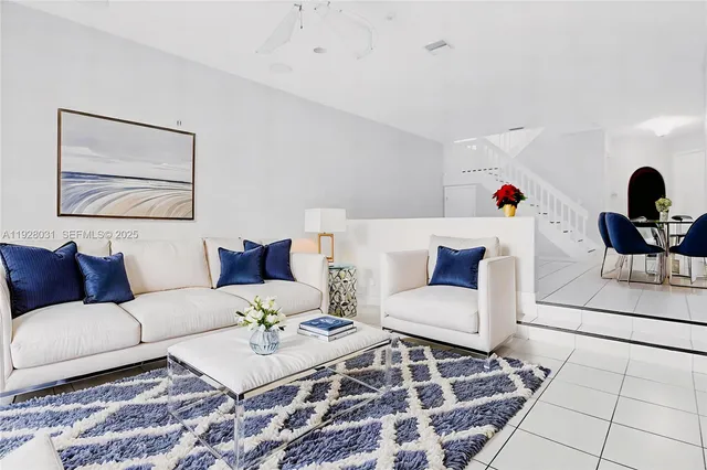a living room with furniture and a rug