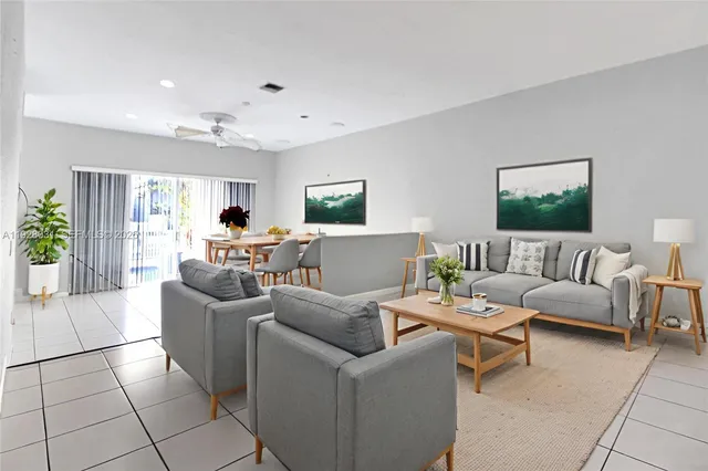 a living room with furniture and a potted plant