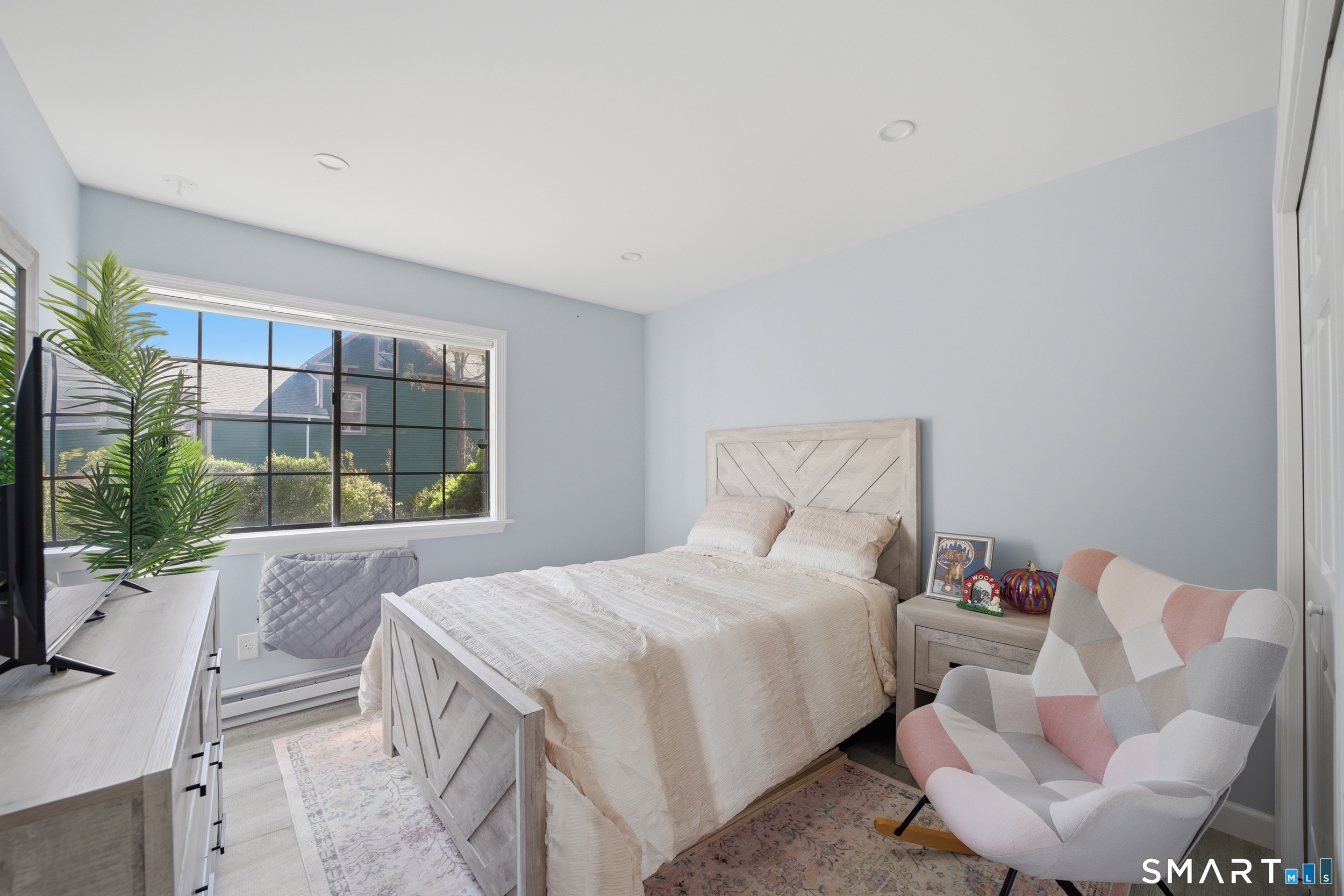 187 Flax Hill Road, Unit D1 Norwalk, CT 06854 - Photo 25 of 32 a bedroom with a bed and a window