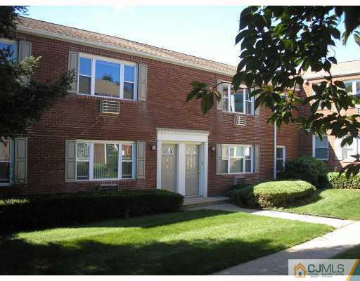 a view of a brick house with a yard