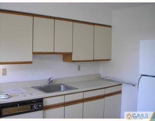 50 Fox Road, Unit 3B Edison, NJ 08817 - Photo 4 of 8 a kitchen with a sink cabinets and stove