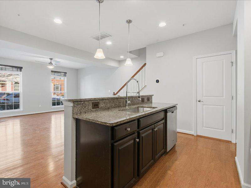 42143 Piebald Square Aldie, VA 20105 - Photo 12 of 34 a kitchen with a stove and a wooden floor