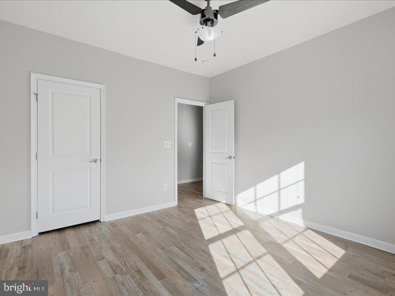 42143 Piebald Square Aldie, VA 20105 - Photo 13 of 34 a view of a livingroom with wooden floor and white walls
