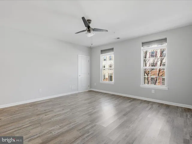 a view of an empty room and wooden floor