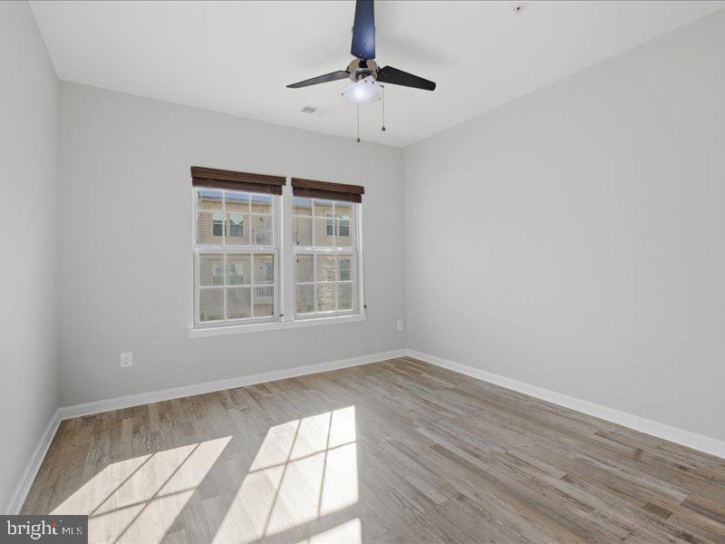 42143 Piebald Square Aldie, VA 20105 - Photo 14 of 34 wooden floor in an empty room with a window