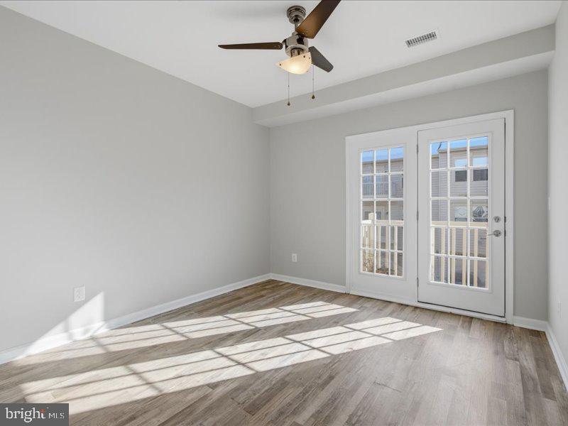 42143 Piebald Square Aldie, VA 20105 - Photo 17 of 34 a view of empty room with wooden floor and fan