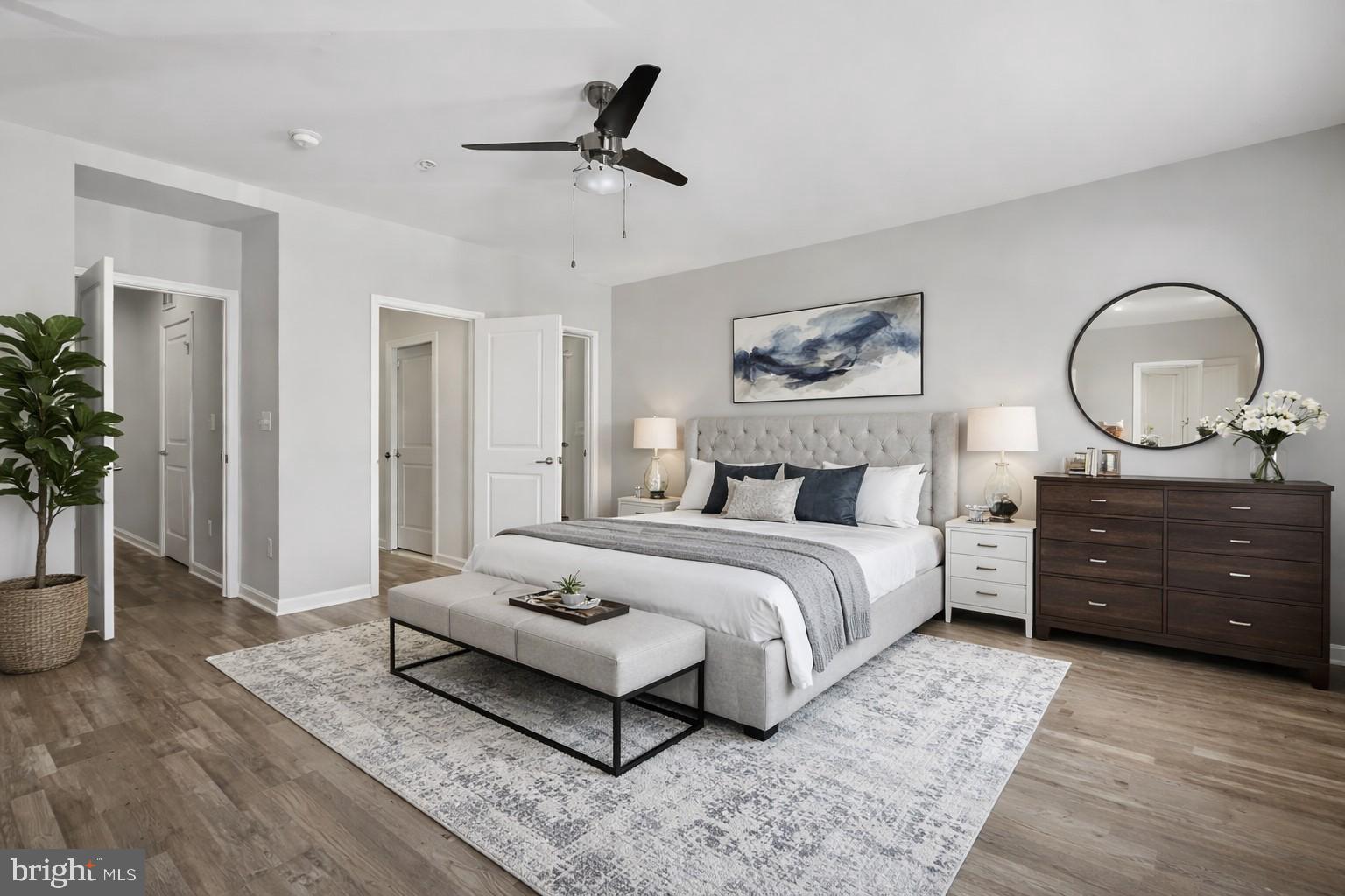 42143 Piebald Square Aldie, VA 20105 - Photo 18 of 34 a spacious bedroom with a bed a dresser and potted plant