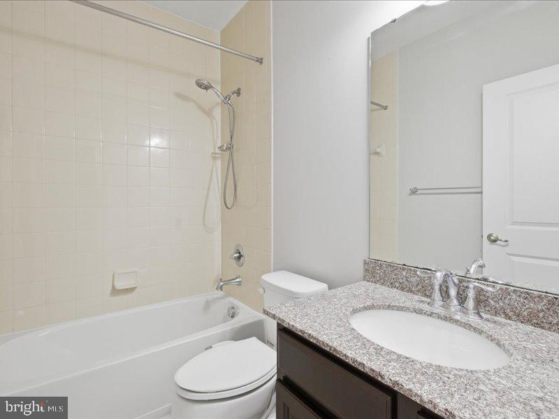 42143 Piebald Square Aldie, VA 20105 - Photo 22 of 34 a bathroom with a granite countertop sink toilet mirror and shower
