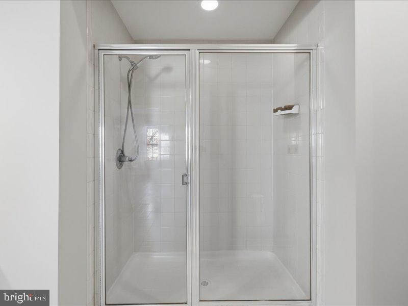 42143 Piebald Square Aldie, VA 20105 - Photo 24 of 34 a bathroom with a glass shower door
