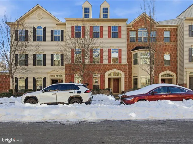 a large kitchen with stainless steel appliances a refrigerator a stove top oven and a sink