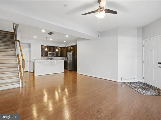 a kitchen with a stove and a wooden floor