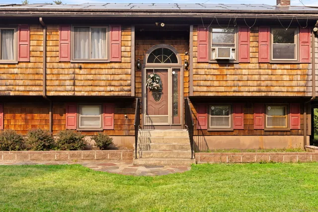 a front view of a house with a yard