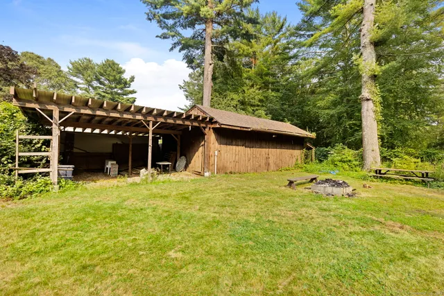 a backyard of a house with table and chairs